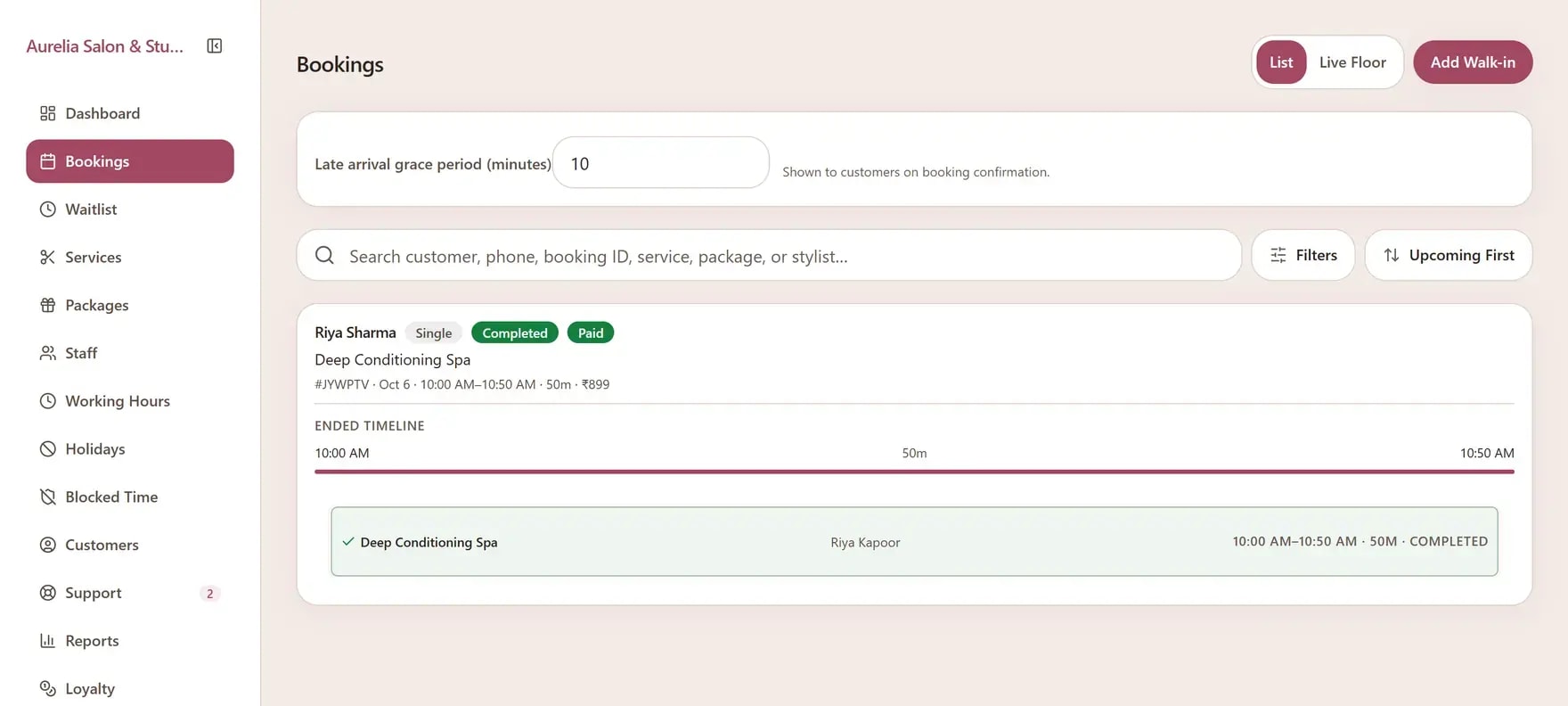 A completed salon appointment on the Apptzy bookings screen, with stylist and payment status.